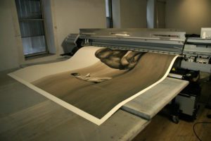 An 8 x 14 foot sheet of triple thick kozo/cotton being printed on a Roland 110" printer with 12 custom inks